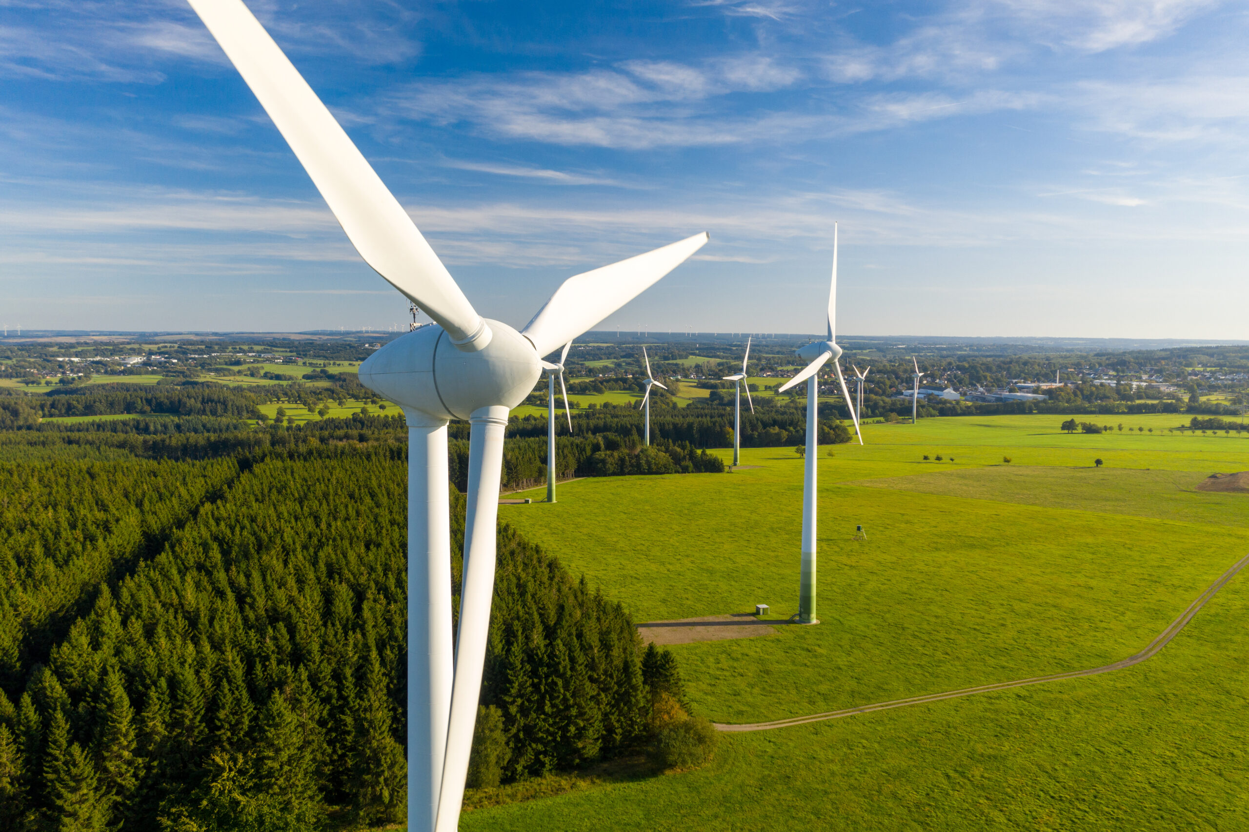 row of wind turbines in a grassy field